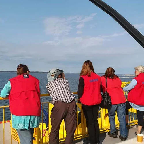 A group of tourist guides working on a ferry in the archipelago